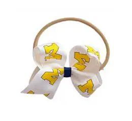 A white and yellow bow with the words michigan wolverines on it.