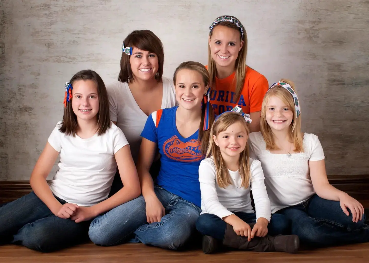 A group of girls posing for a family photo.