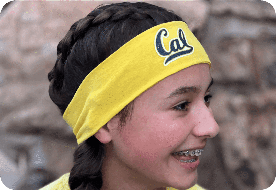 Girl with yellow headband and braided hair.