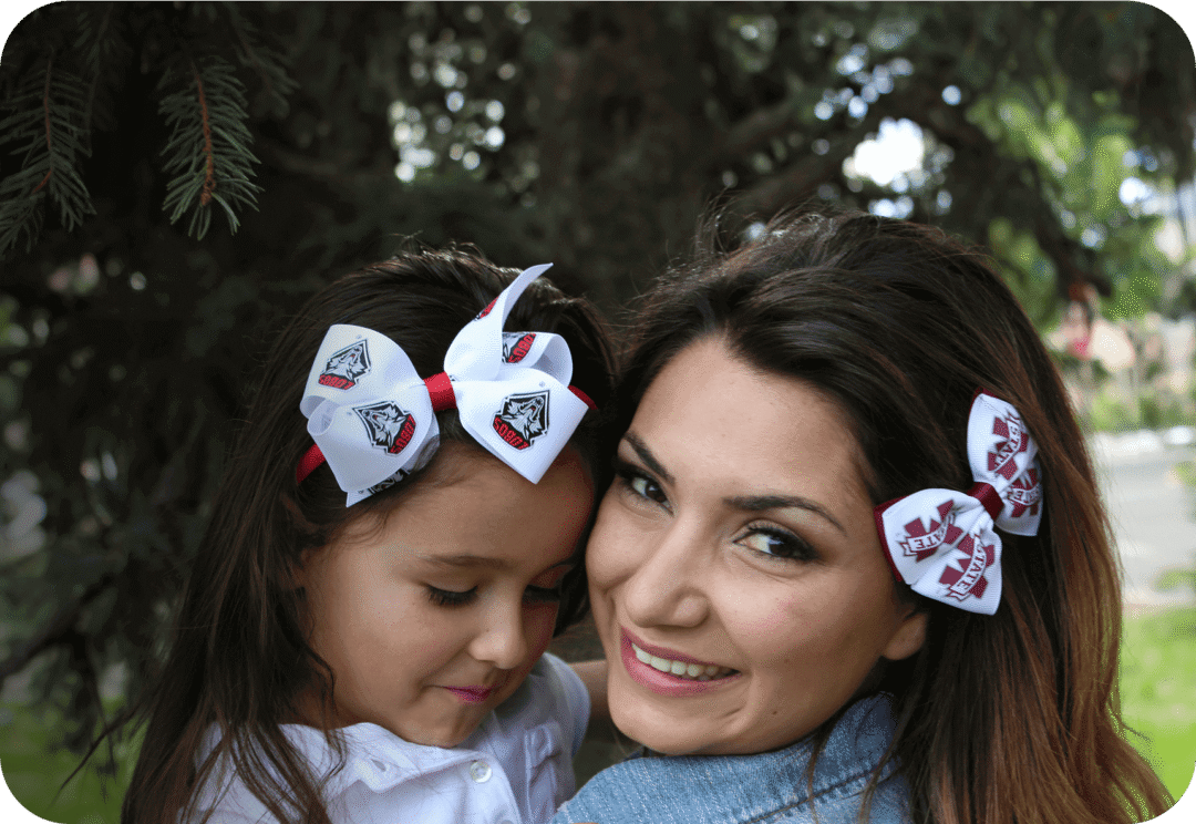 Mother and daughter with matching hair bows.