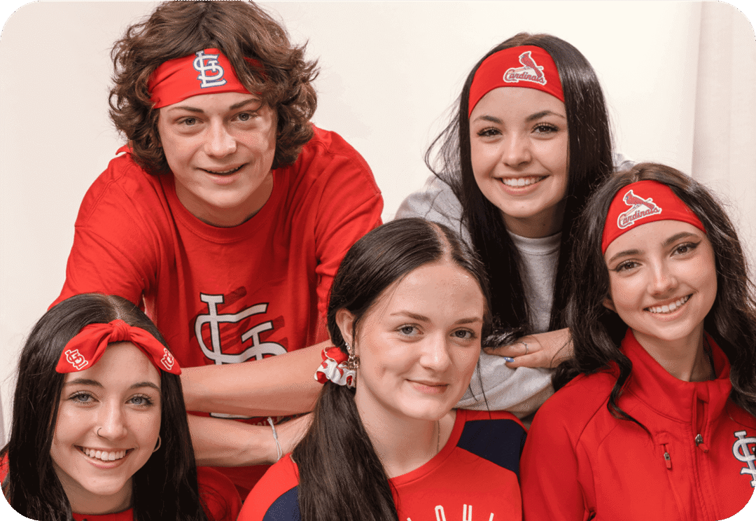 Group of smiling people wearing matching headbands.